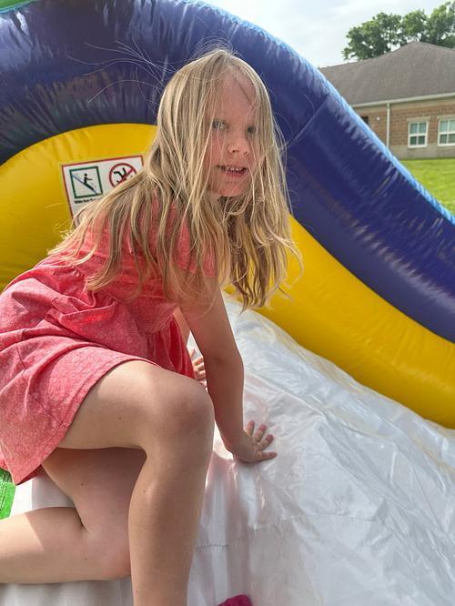 people in  a colorful bouncy house
