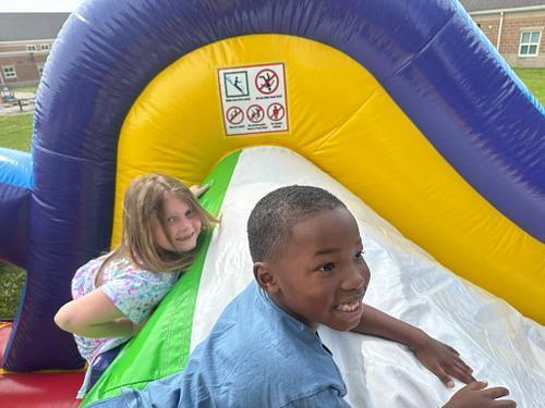 people in  a colorful bouncy house