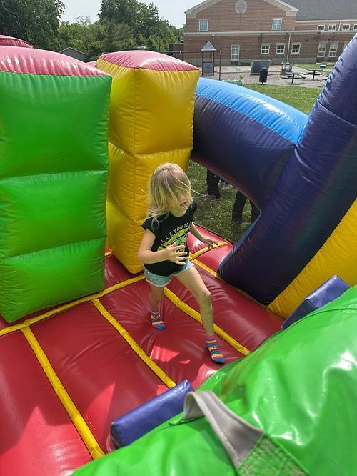 people in  a colorful bouncy house