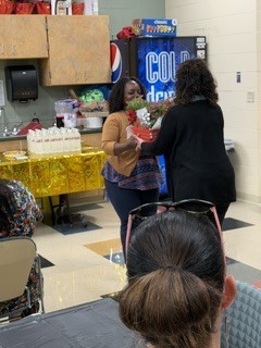 person handing another person a gift