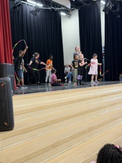 people on a stage with ribbons