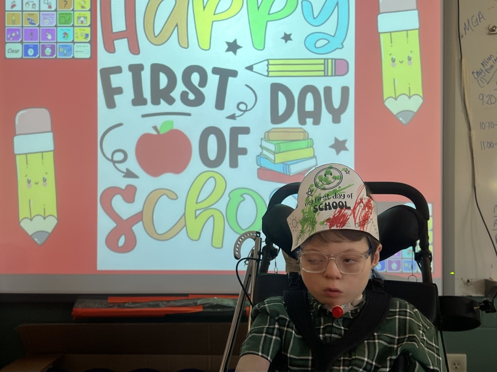 one student in front of a first day of school picture