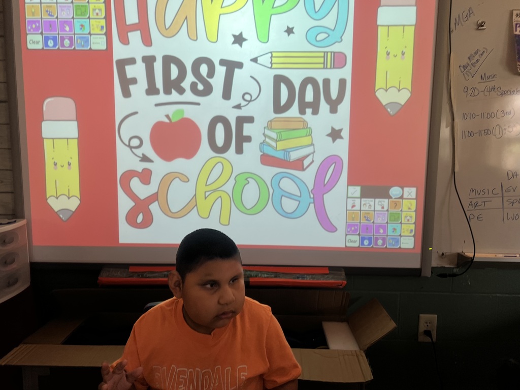one student in front of a first day of school picture