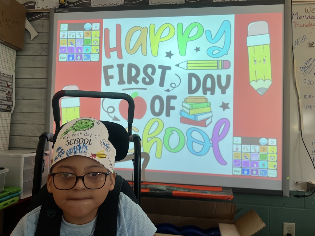 one student in front of a first day of school picture
