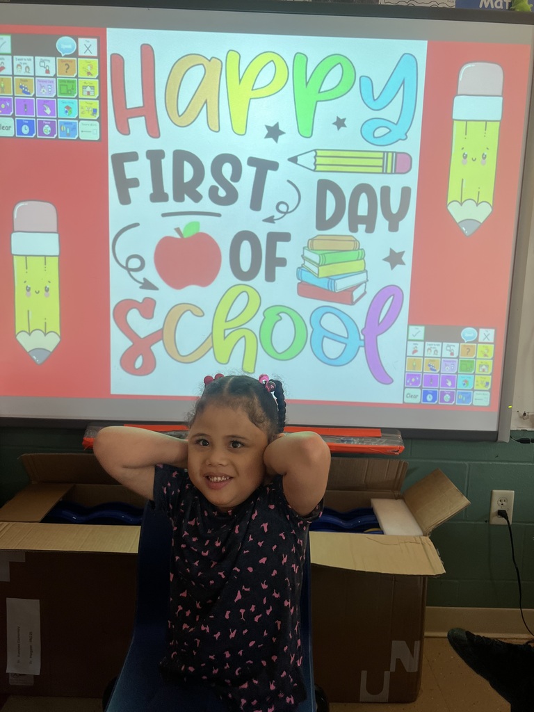 one student in front of a first day of school picture
