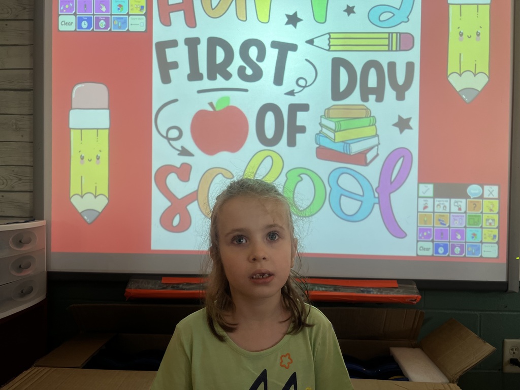 one student in front of a first day of school picture