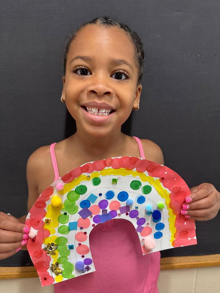 student holding a paper with colorful decorations