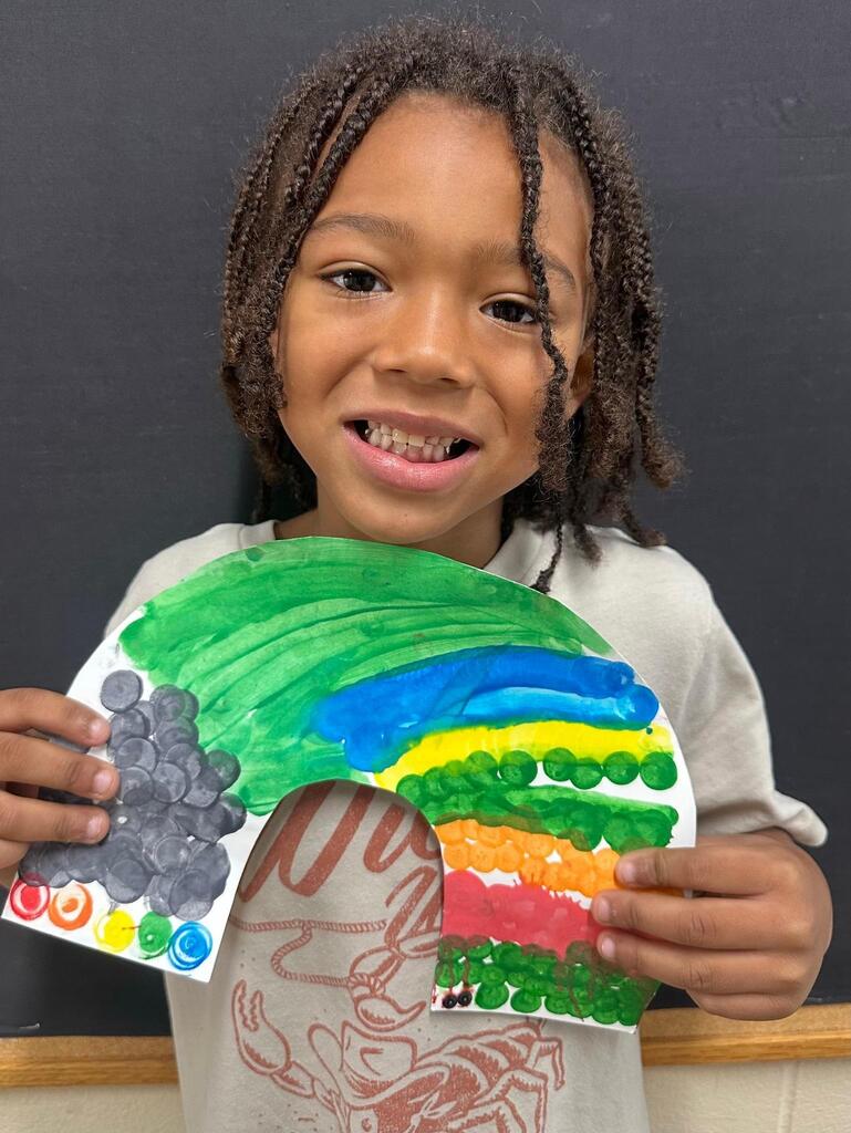 student holding a paper with colorful decorations