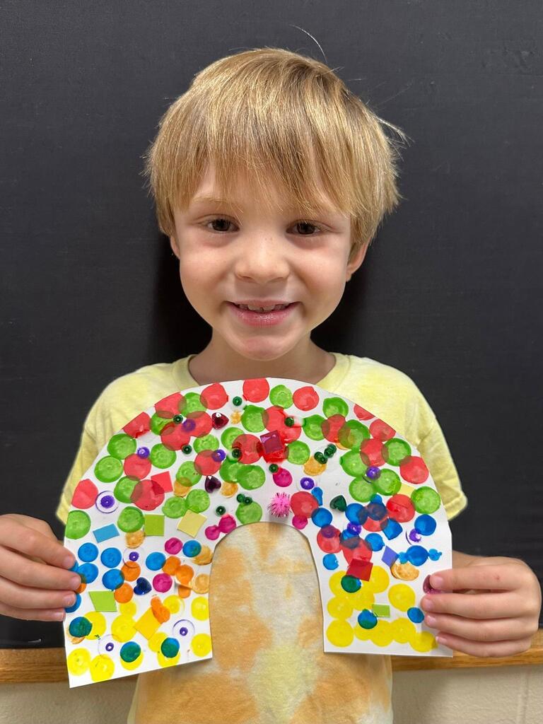 student holding a paper with colorful decorations
