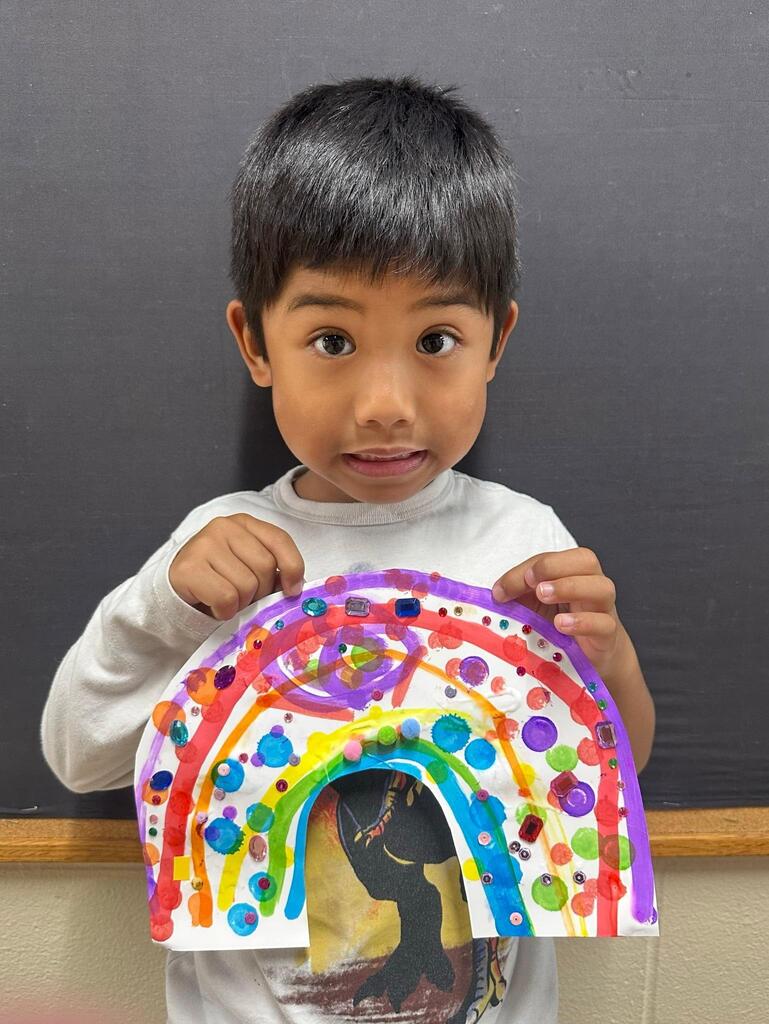 student holding a paper with colorful decorations