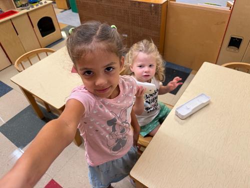 two students with phones in the play corner