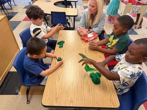 people in a classroom sittng at a table with sticky slime