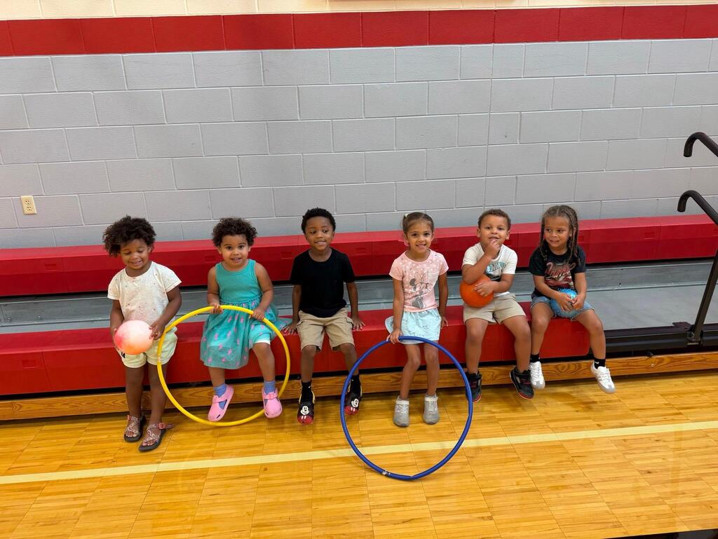 students in the gymnasium with hoops