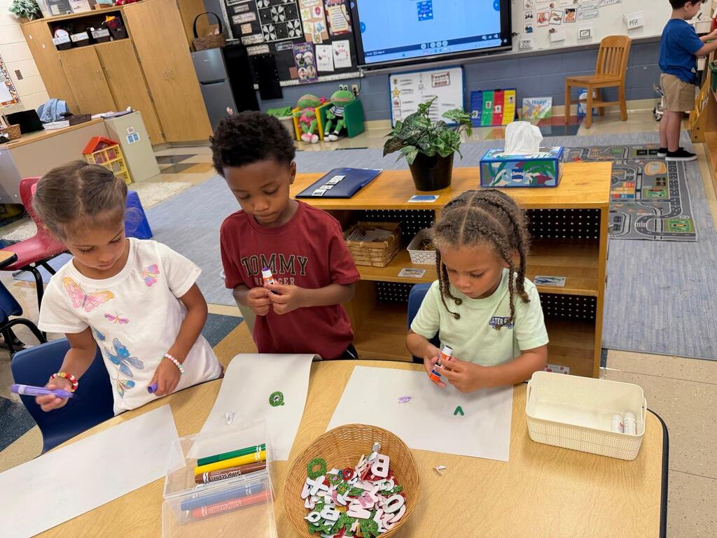 students using glue sticks and paper