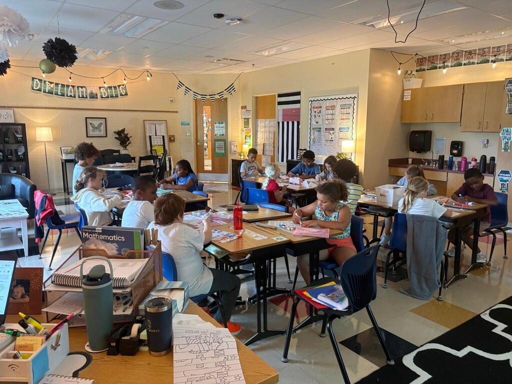 students in a clasroom at tables
