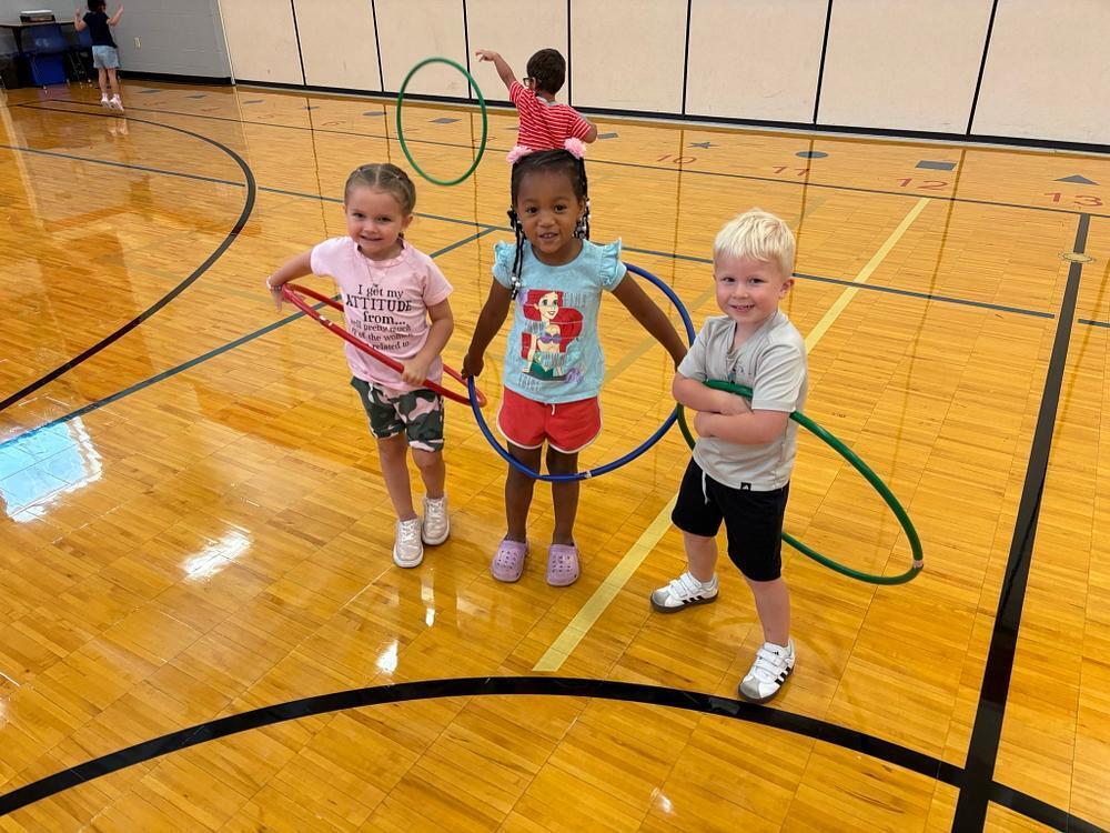students in the gymnasium with hoops