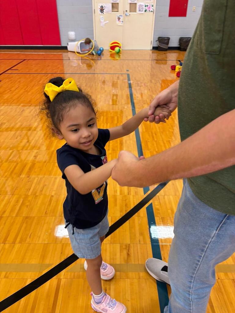 two people in the gym holding hands