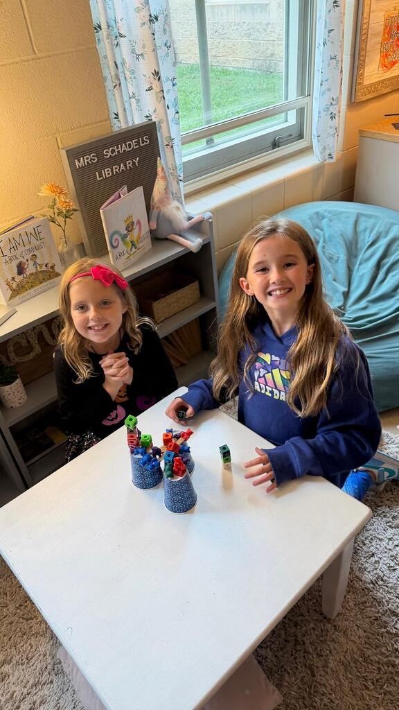 students sitting with cup and plastic bears 