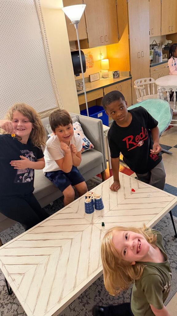 students sitting with cup and plastic bears 