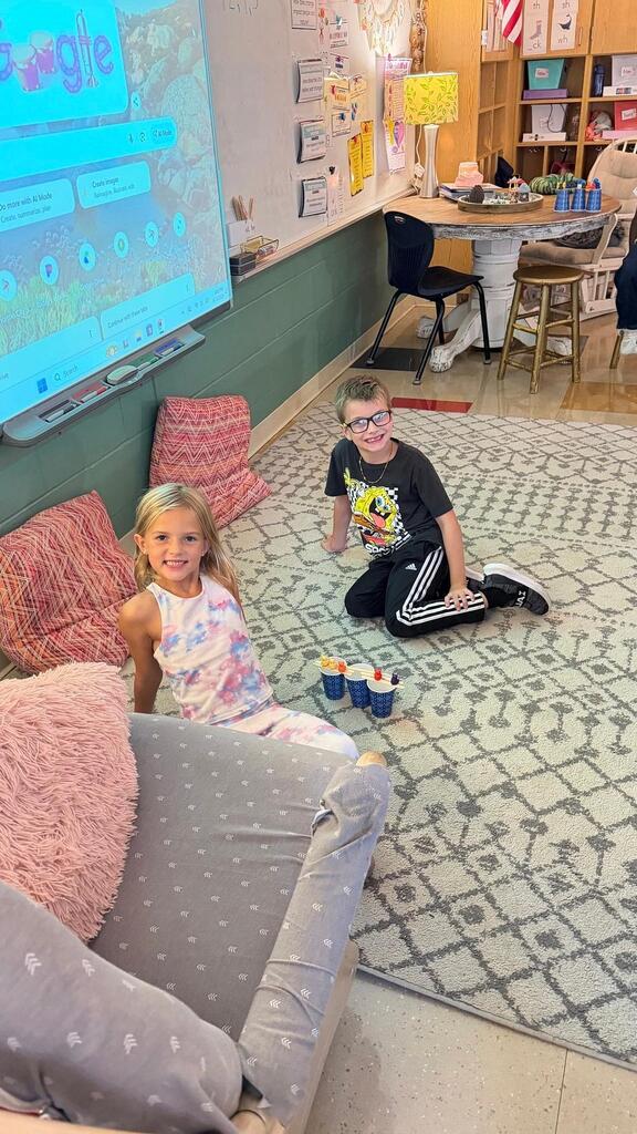 students sitting with cup and plastic bears 