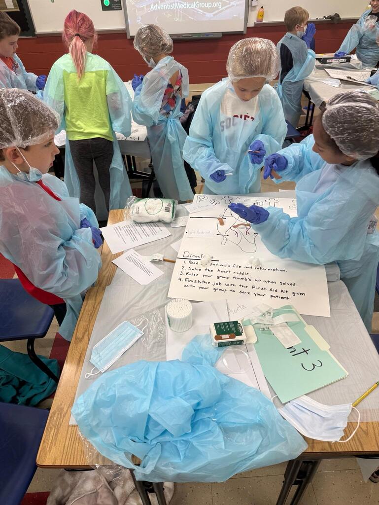 people in a classroom dressed in surgeon outfits