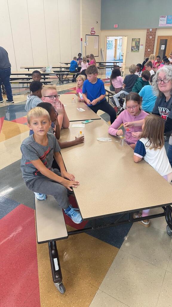 students working at a table in the cafeteria