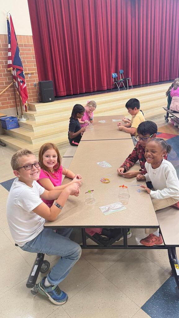 students working at a table in the cafeteria