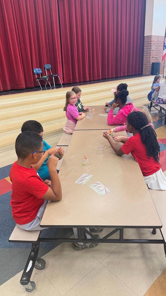 students working at a table in the cafeteria