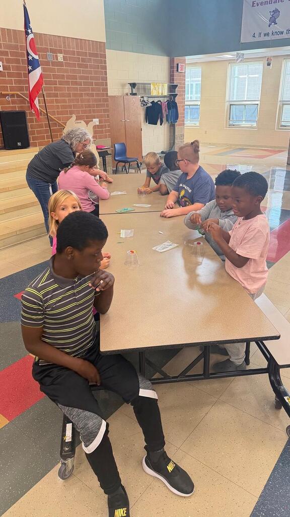 students working at a table in the cafeteria