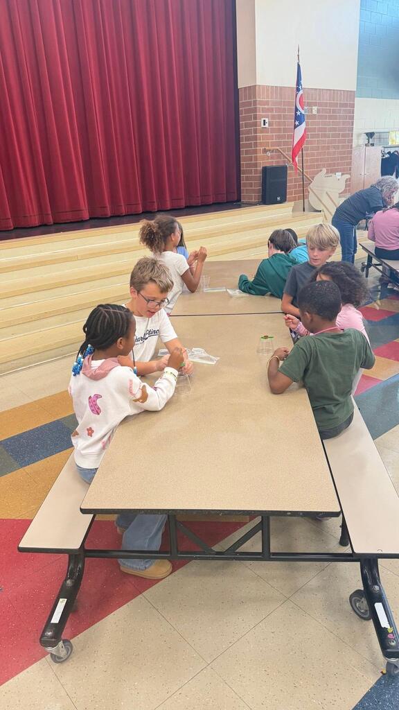 students working at a table in the cafeteria