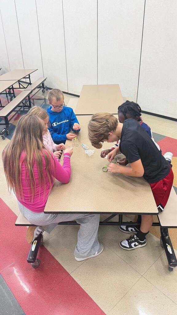 students working at a table in the cafeteria