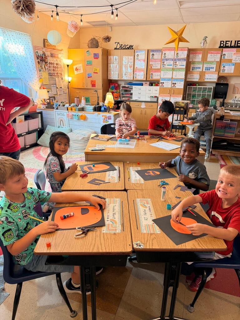 people around a table making crafts