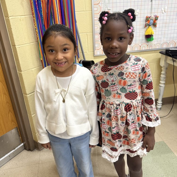 first grade girls smiling on fall picture day 2026