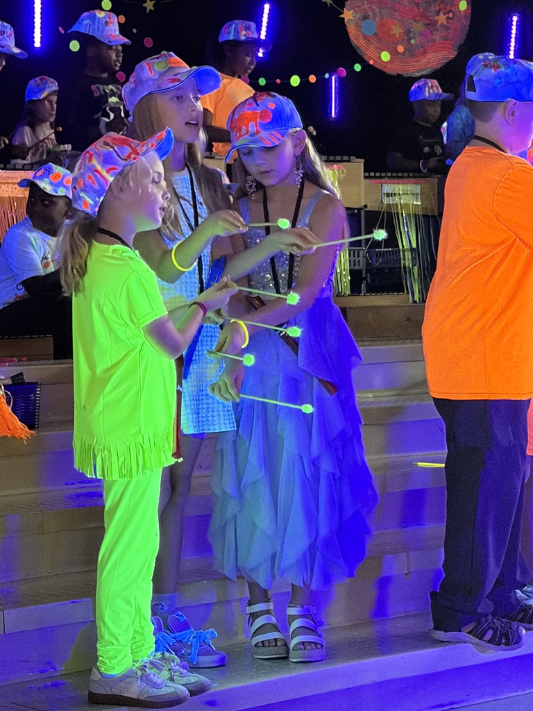 people dressed in neon clothes with instruments