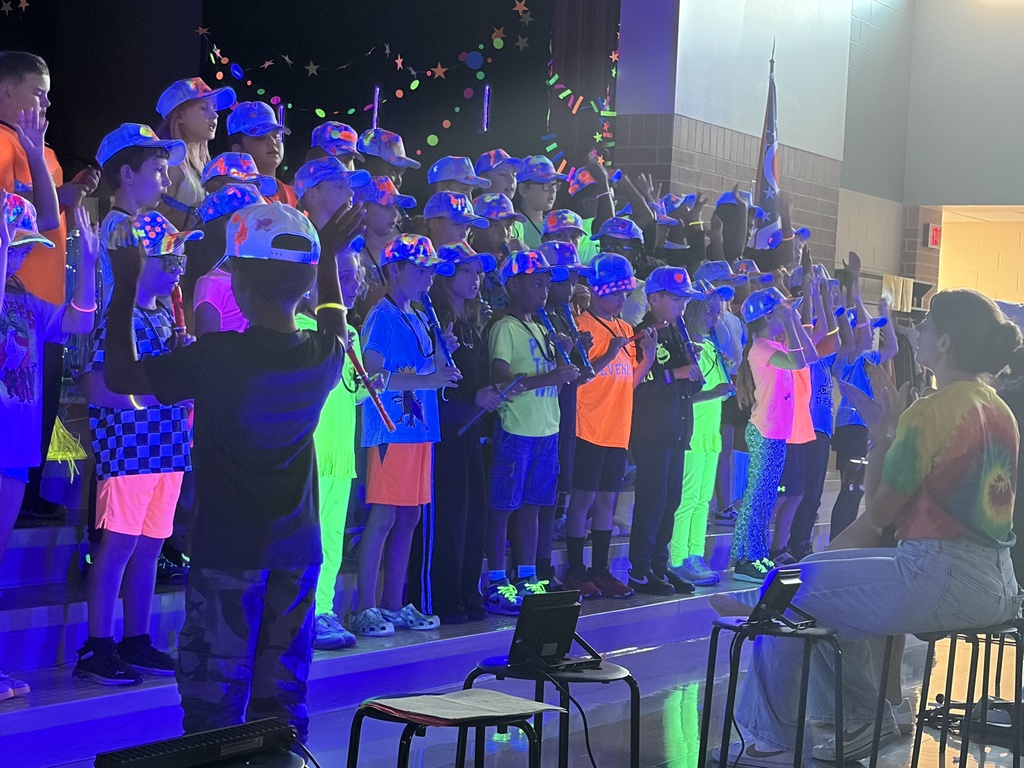 people dressed in neon clothes with instruments