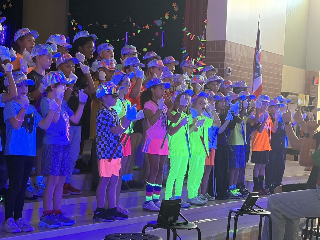 people dressed in neon clothes with instruments