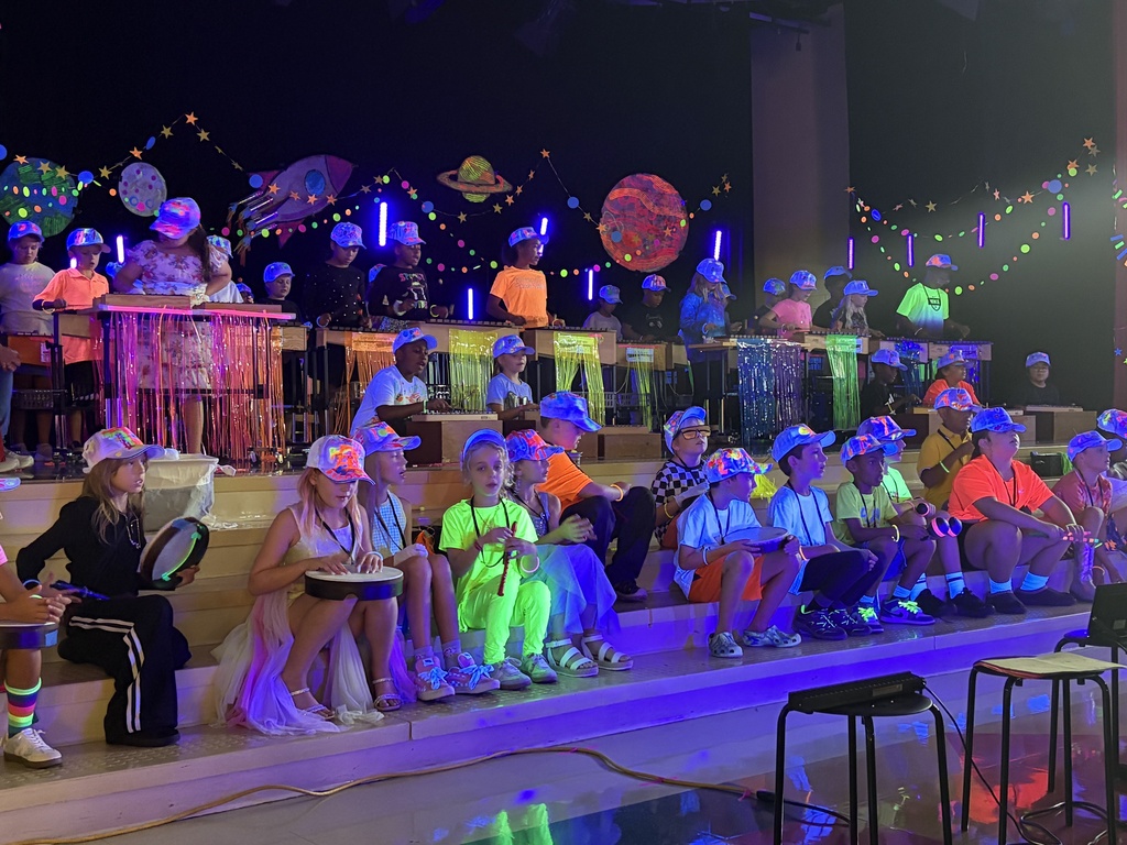 people dressed in neon clothes with instruments