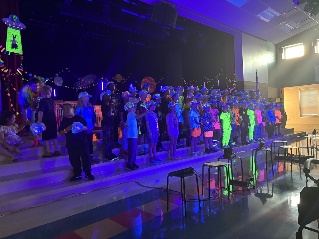 people dressed in neon clothes with instruments