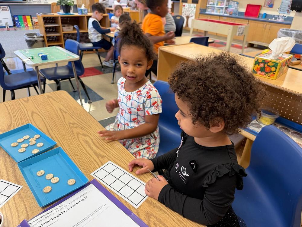 students at a talbe with math items