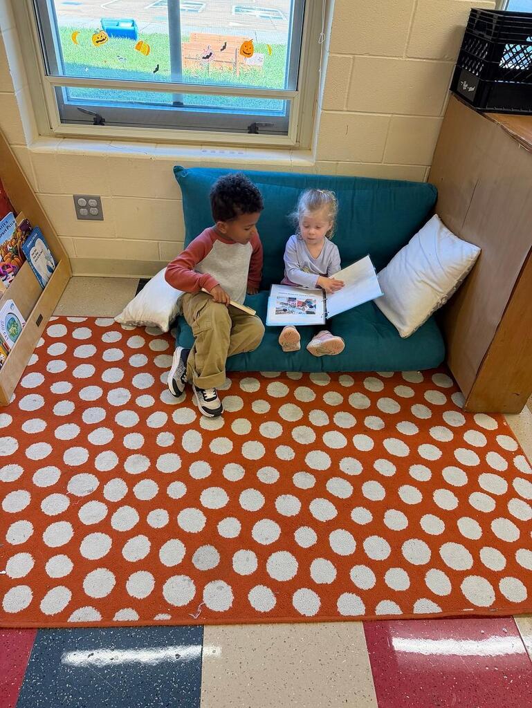 people reading books on a couch