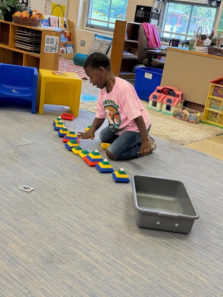 person on the carpet with blocks 