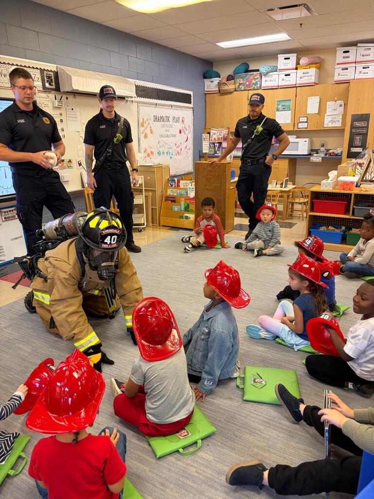 people wearing fire helmets in a room 