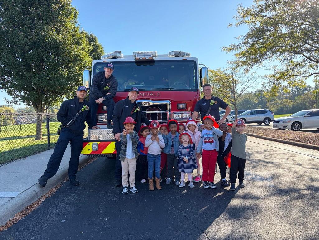 people standing in front of a fire engine