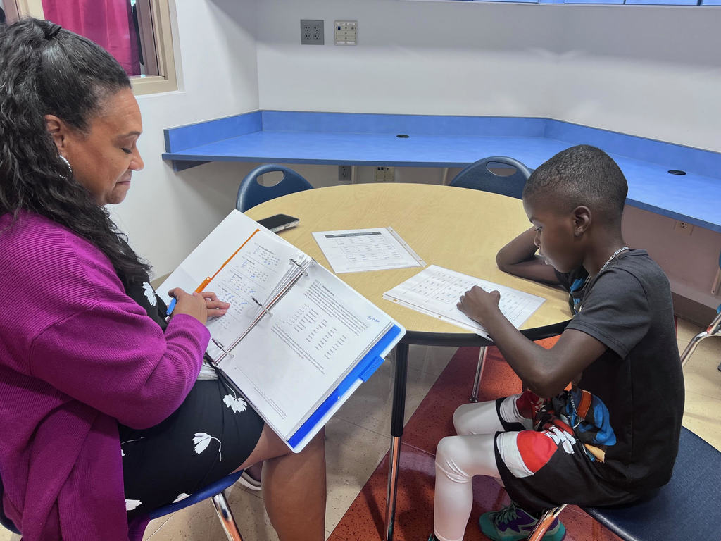 Mrs. Butler working with students