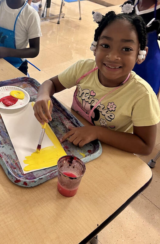 1st graders learning about primary and secondary colors through painting.