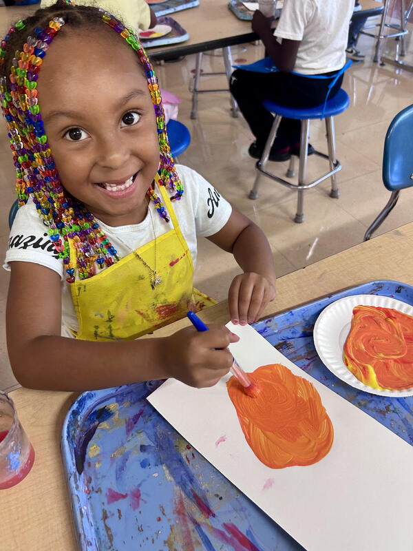 1st graders learning about primary and secondary colors through painting.