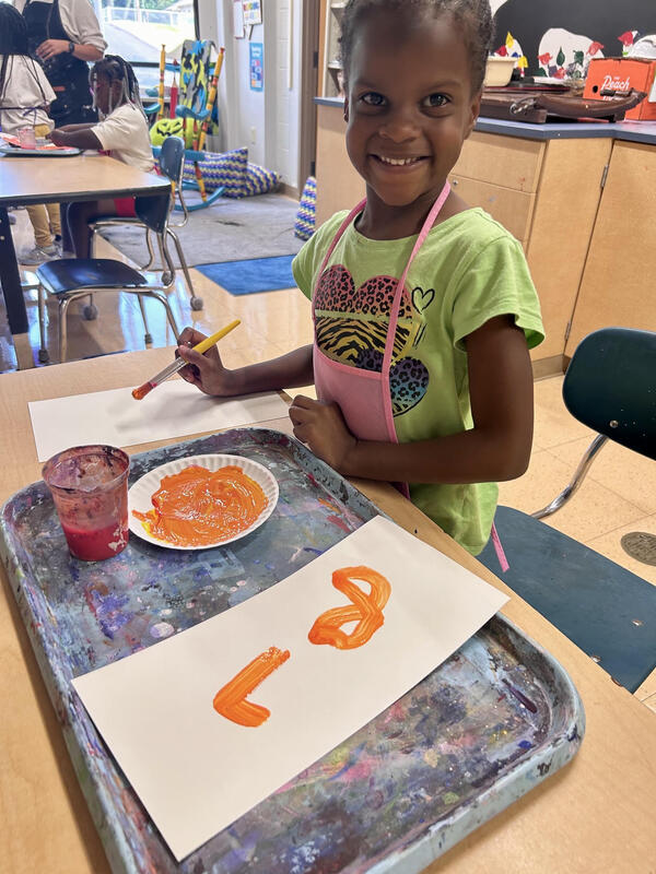1st graders learning about primary and secondary colors through painting.