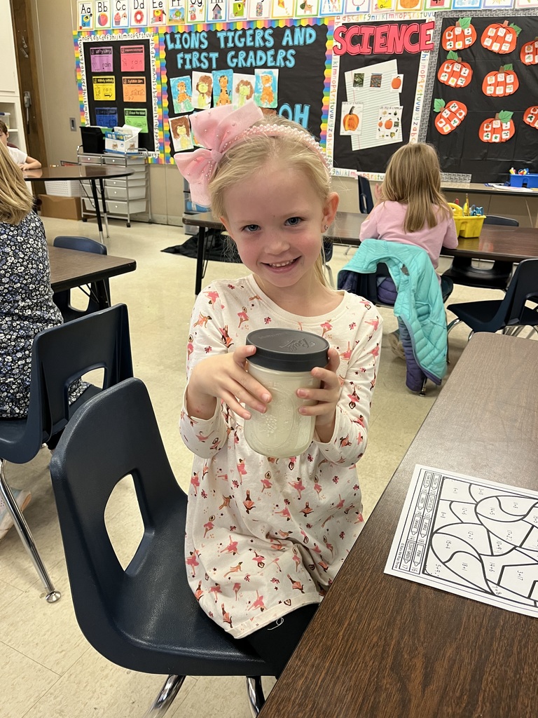 student hold jar of homemade butter