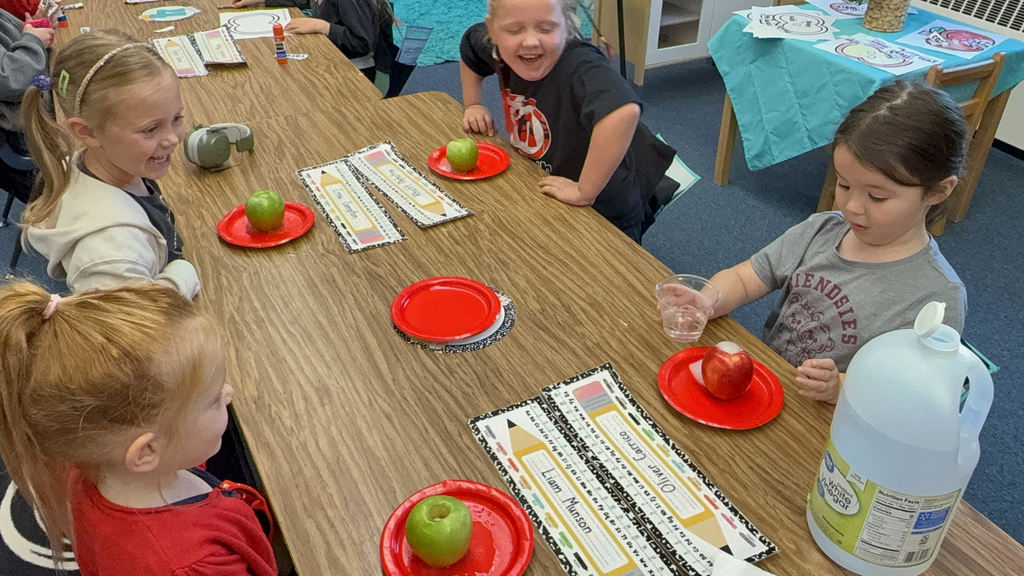 Douglas Kindergarten students celebrating Apple Day with a sweet snack
