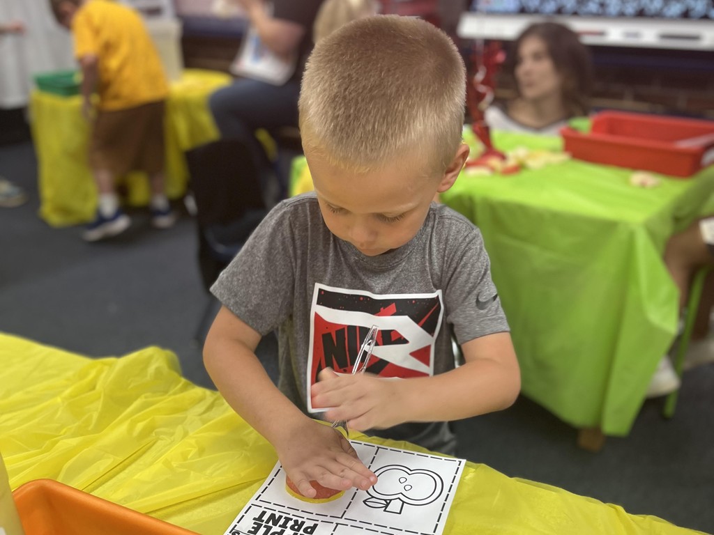 Douglas Kindergarten student doing an Apple Day activity